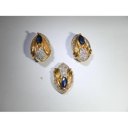 40 - An 18ct gold sapphire and diamond pendant and earring set. 7.3 grams.