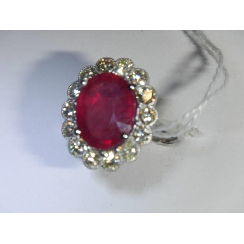 48 - A 6.5 carat oval ruby platinum and diamond ring, size N half, 8 grams.