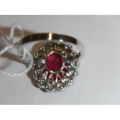 48 - A 6.5 carat oval ruby platinum and diamond ring, size N half, 8 grams.