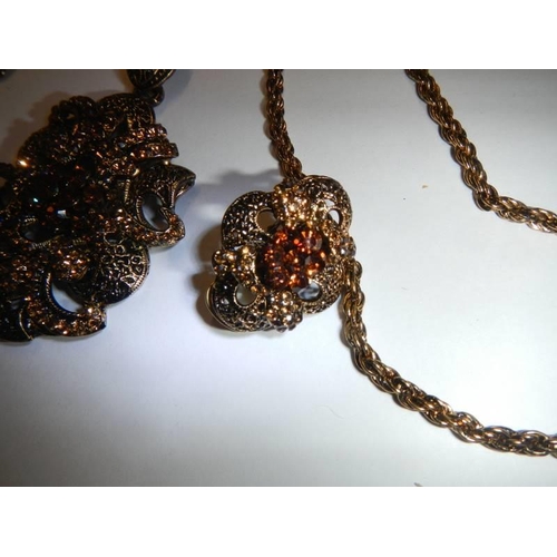 50 - A vintage ornate pendant with matching earrings.