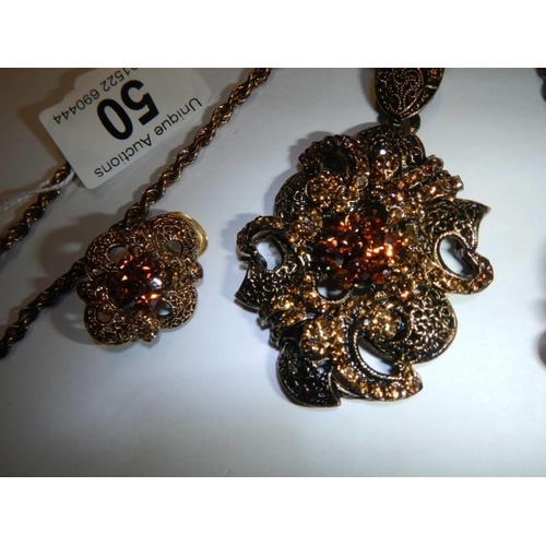 50 - A vintage ornate pendant with matching earrings.