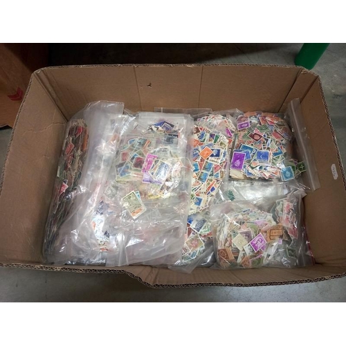 786 - A quantity of bags of loose stamps