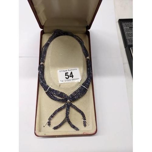 54 - A graduated four strand tanzanite necklace with a tassel style drop.