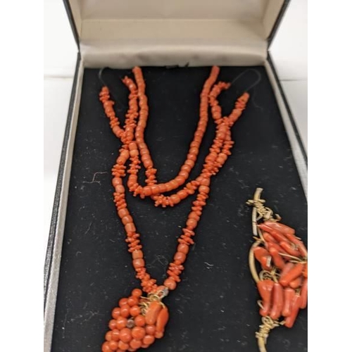 59 - A red coral necklace with attached pendant and a 19th century similar brooch.