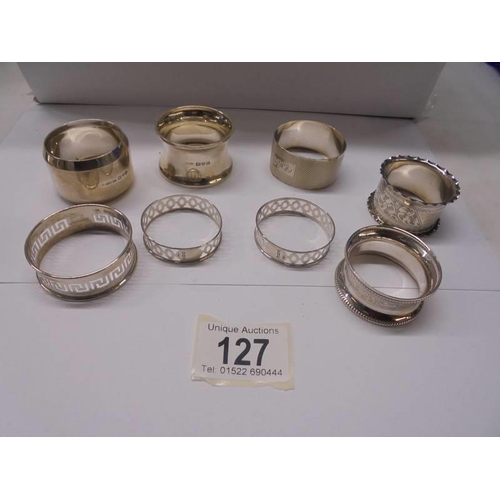 127 - Eight hall marked silver napkin rings, 90 grams.