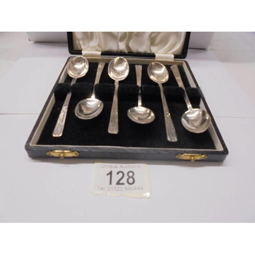 128 - A cased set of six hall marked silver tea spoons, 105 grams.