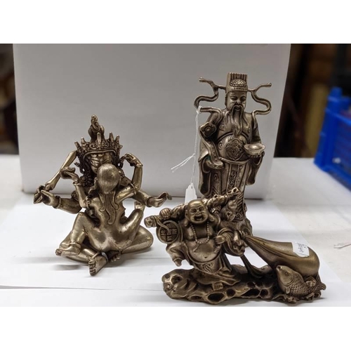 203 - A Chinese erotic figure group and two Buddhas in metal.