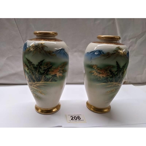 206 - A pair of Japanese watermill vases, signature base ring.