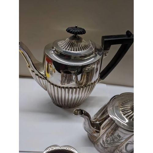 211 - A three piece silver plate tea set, coffee pot and water jug.