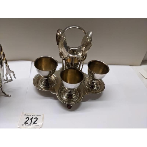 212 - A silver plate egg cup stand and a pickle jar on silver plate stand.