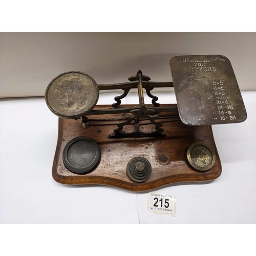 215 - A set of Victorian brass postal scales with weights,