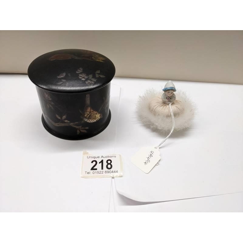 218 - A Japanese lacquered chinioserie box and a swan down powder puff,