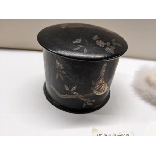 218 - A Japanese lacquered chinioserie box and a swan down powder puff,