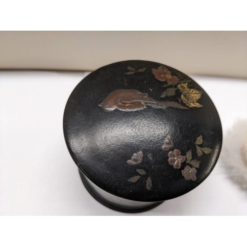 218 - A Japanese lacquered chinioserie box and a swan down powder puff,