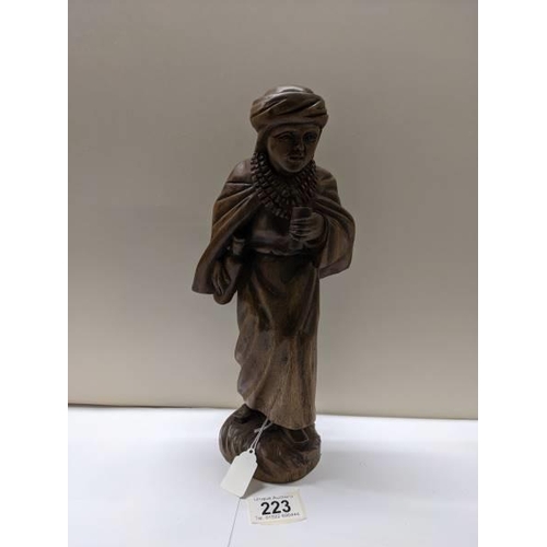 223 - A carved wood figure of a boy, (30 cent hiwat).