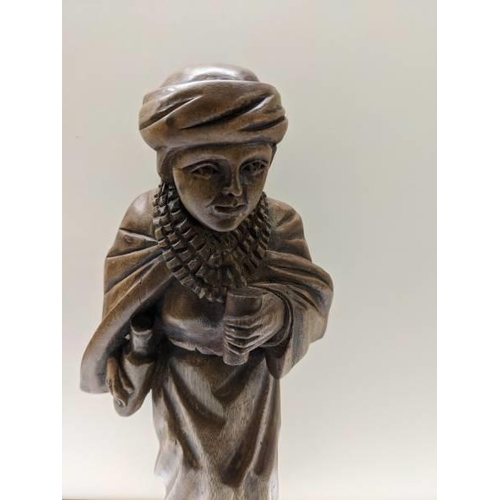 223 - A carved wood figure of a boy, (30 cent hiwat).