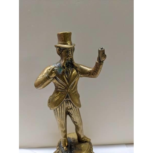 224 - A Victorian brass figure bar top mains gas lighter, 24 cm tall.