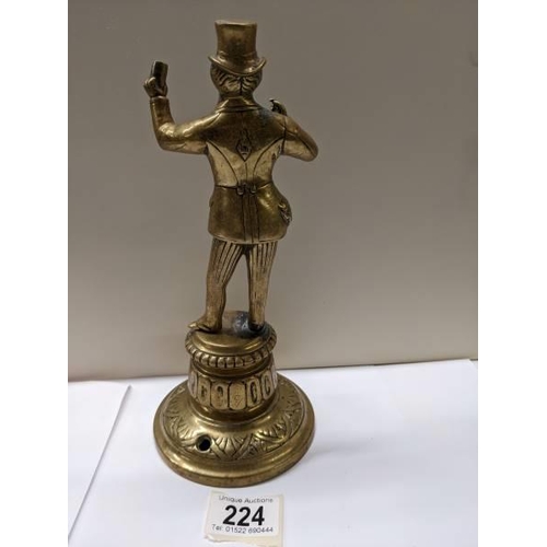 224 - A Victorian brass figure bar top mains gas lighter, 24 cm tall.