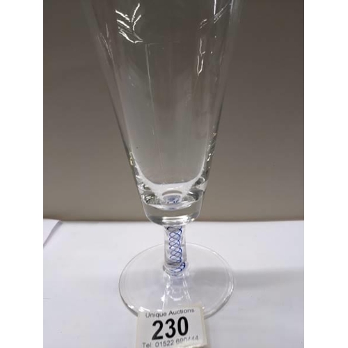 230 - An early stemmed glass with blue twist stem.