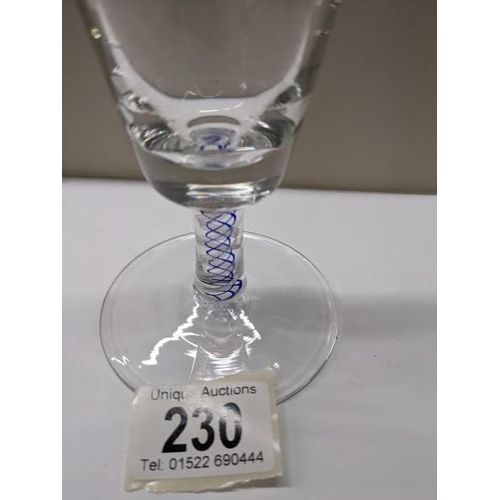 230 - An early stemmed glass with blue twist stem.