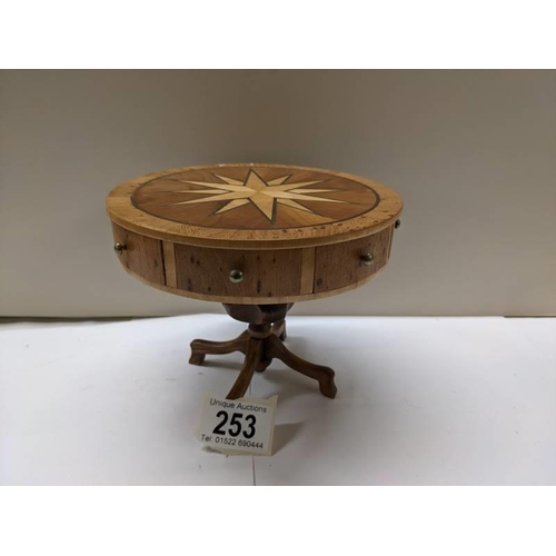 253 - An apprentice piece inlaid drum table with opening drawers.