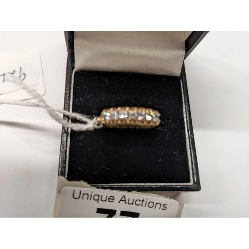 77 - A 9ct gold seven stone ring, size Q. 2.6 grams.