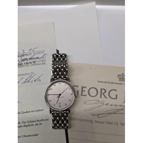 79 - A Georg Jensen automatic gents wrist watch with receipt and guarantee, dated 1995 in German.