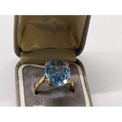 86 - A 9ct gold ring set large topaz, size R half, 5.6 grams.