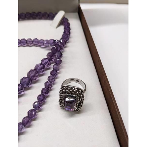 94 - A long natural amethyst necklace and an amethyst ring circa 1970's in a heavy textured mount.