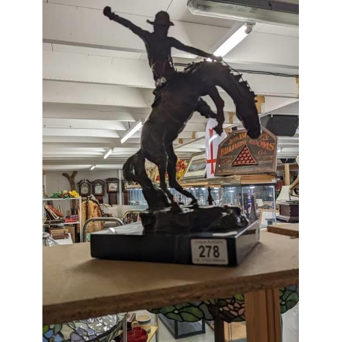 278 - A bronze cowboy on a rearing horse mounted on a marble base, signed Kouba.