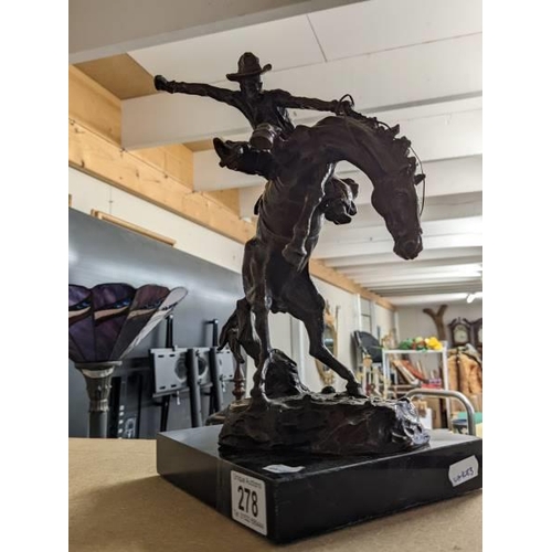 278 - A bronze cowboy on a rearing horse mounted on a marble base, signed Kouba.