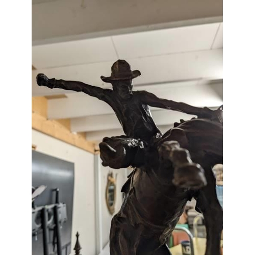 278 - A bronze cowboy on a rearing horse mounted on a marble base, signed Kouba.