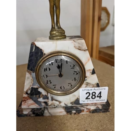 284 - An art deco marble mantel clock surmounted figure, base 13 x 4.5 cm, height 19.5 cm.