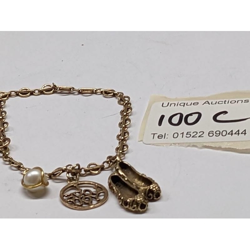 100C - A 9ct gold bracelet with three gold charms, 8 grams.