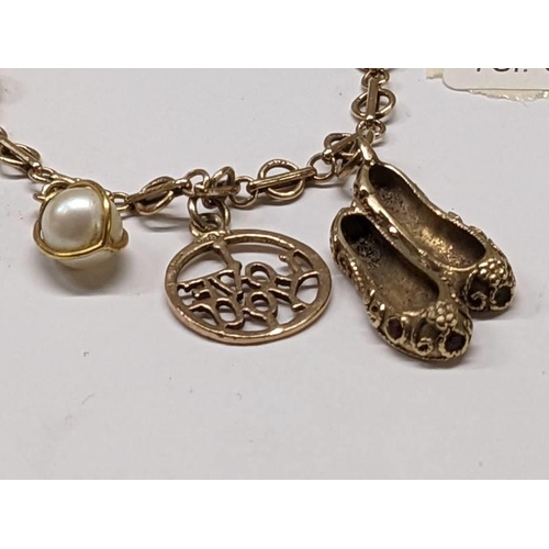 100C - A 9ct gold bracelet with three gold charms, 8 grams.