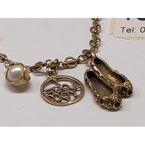 100C - A 9ct gold bracelet with three gold charms, 8 grams.