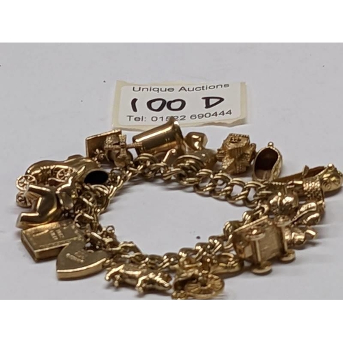 100D - A 9ct gold charm bracelet with 15 charms, in good condition, 41 grams.