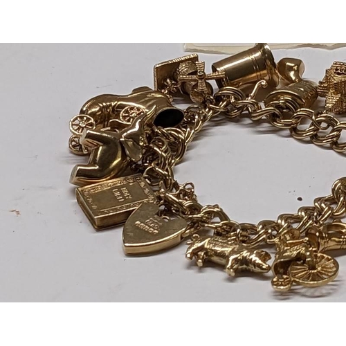 100D - A 9ct gold charm bracelet with 15 charms, in good condition, 41 grams.