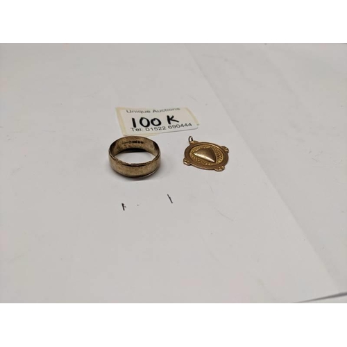 100K - A gold wedding ring and a gold watch fob. 7 grams.