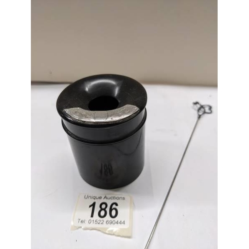 186 - An ebony hair pot with silver mount and a long silver hat pin by Charles Horner.