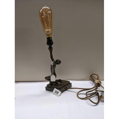 308 - An art deco style figural table lamp.