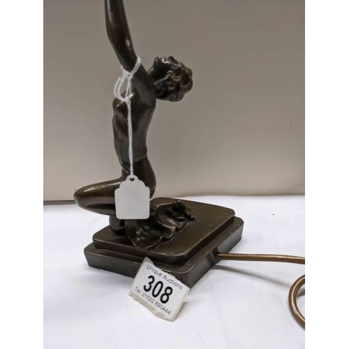 308 - An art deco style figural table lamp.