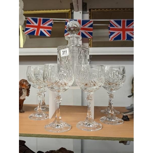 311 - A cut glass decanter and six goblets.