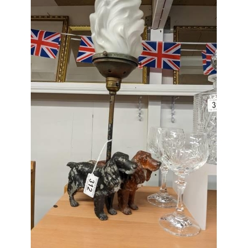 312 - An early 20th century cocker spaniel table lamp with flame glass shade.