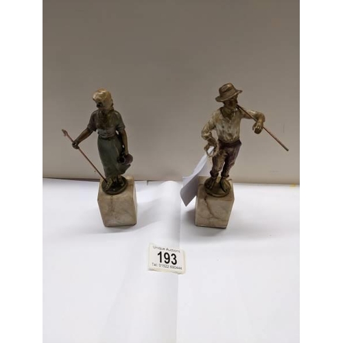 193 - A pair of cold painted bronzes of a shepherdess and a tramp on marble bases, early 20th century. Bot... 