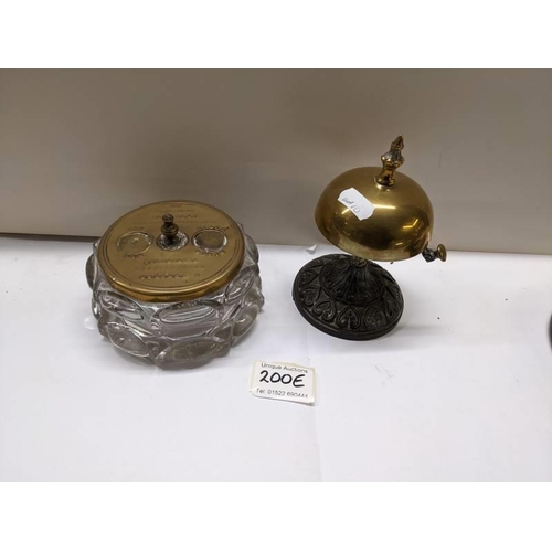 200E - A brass shop bell and a glass inkwell with brass top.