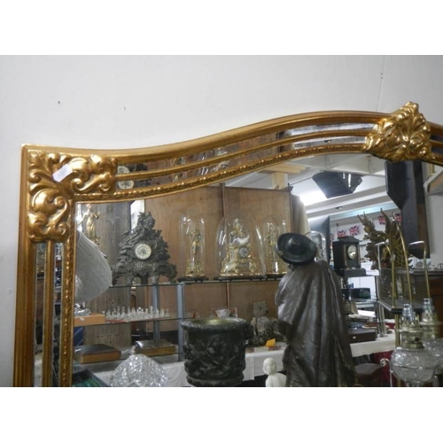 323 - A large gilt framed overmantel mirror. COLLECT ONLY.