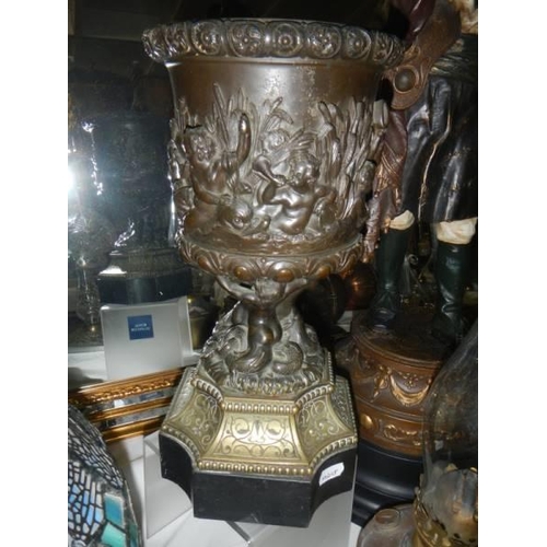 328 - An early oil lamp base featuring cherubs together with a copper font with burner and chimney.