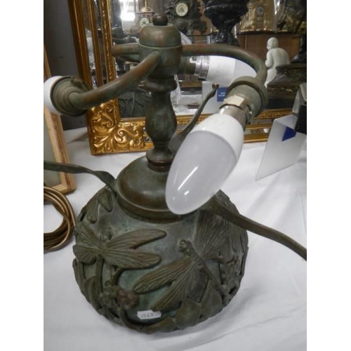 331 - A bronze table lamp with Tiffany style dragon fly shade.