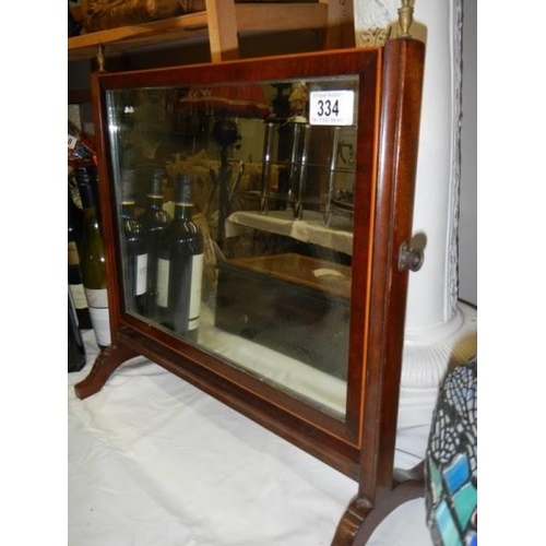 334 - An Edwardian mahogany toilet mirror.